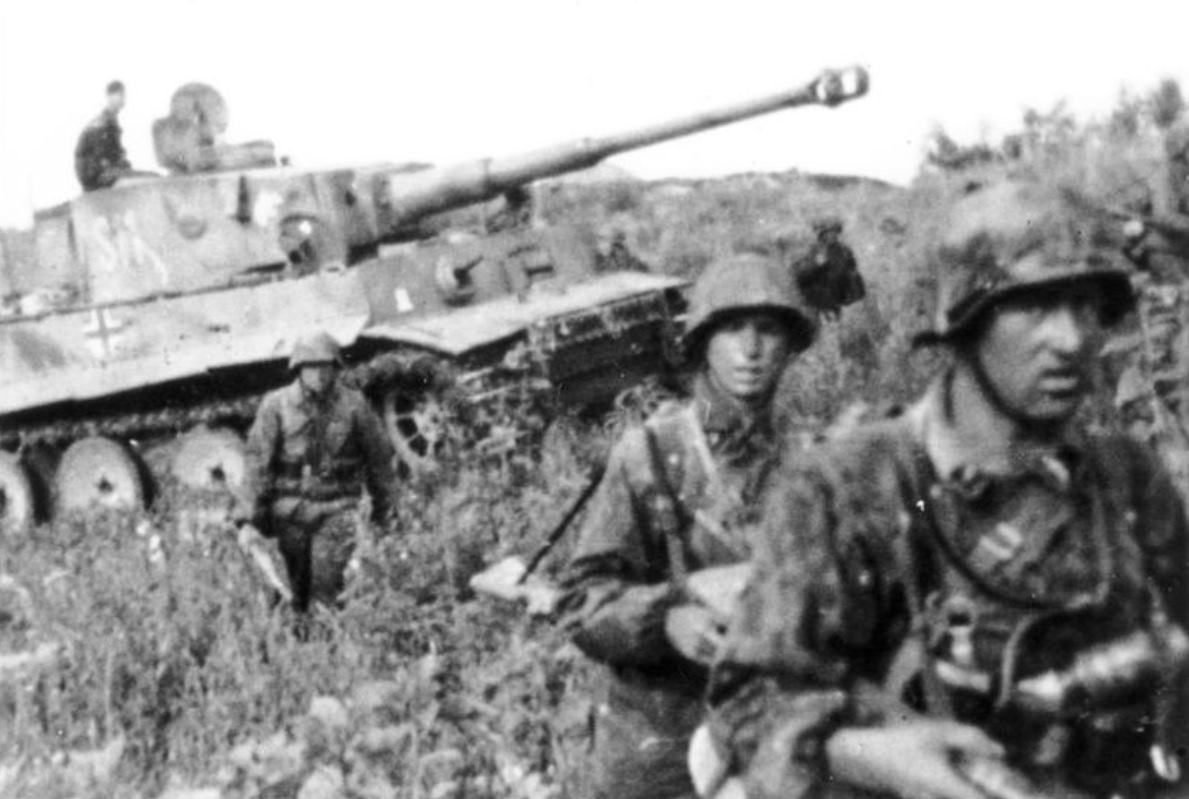 1944 April, Area around Smolensk. A Tiger tank accompanied by infantry in difficult terrain on the way east to break through the Russian defense line.