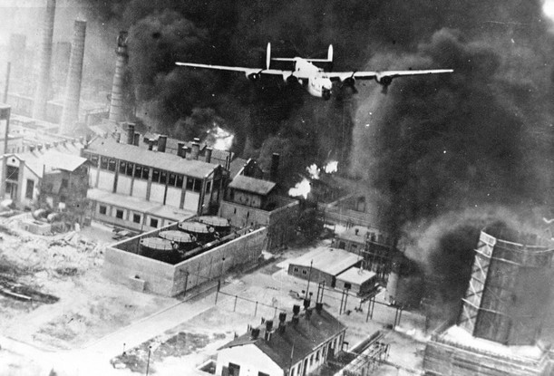 B-24 flying over a burning oil refinery at Ploesti, Rumania.jpg